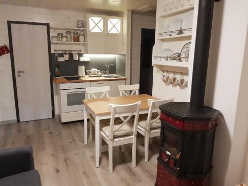 a kitchen with a table and chairs and a stove at Geofond Chata 1 in Chotěboř