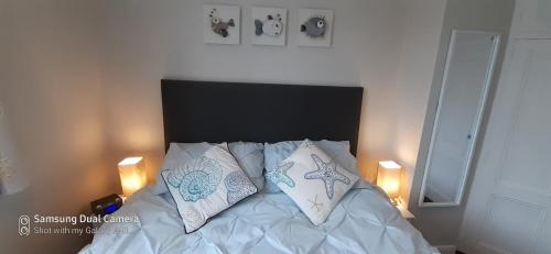 a bedroom with a bed with two pillows on it at Hartendale in Flamborough