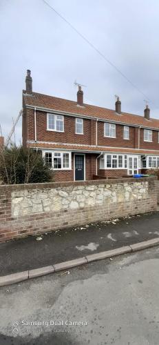 a brick house on the side of a street at Hartendale in Flamborough
