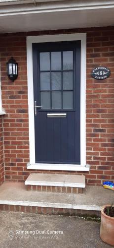 a blue front door of a brick house at Hartendale in Flamborough