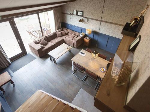 an overhead view of a living room with a couch and a table at Elegant Holiday Home with Horssen with Terrace in Horssen