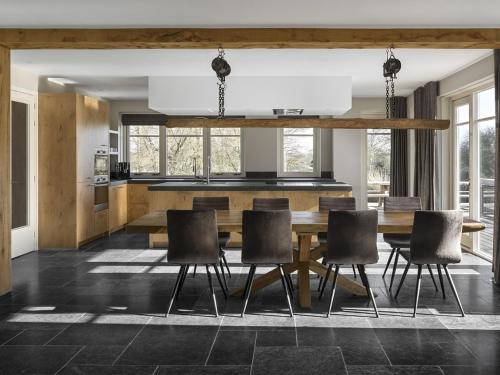 a dining room with a wooden table and chairs at Holiday Home with bubble bath in Noordwijk in Noordwijk