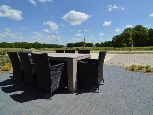 a table and chairs sitting on a patio at Pretty Farmhouse in Haaksbergen near Forest in Haaksbergen