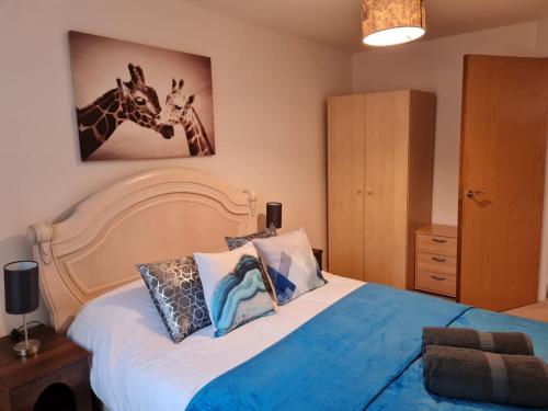 a bedroom with a bed with two giraffes on the wall at Patton Place, Warrington, 1 Bedroom, Safari Themed, High Speed WiFi, Smart TV, Amazing Train Links, Secure Location, Hotel Vibe in a Home in Great Sankey