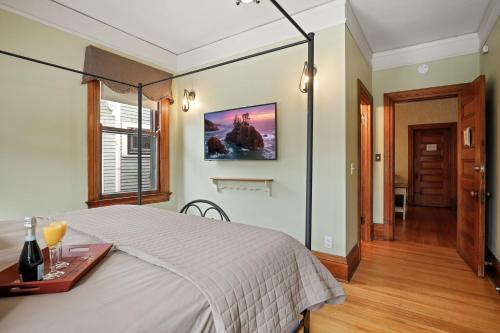a bedroom with a bed and a table and a picture on the wall at Historic District BnB in Saint Paul
