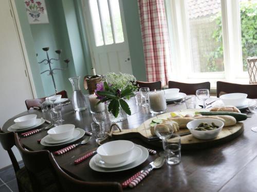 a dining room table with a plate of food on it at Peaceful Farmhouse in Doorn near Forest in Doorn