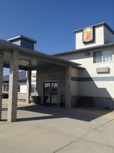 a building with a sign on the side of it at Super 8 by Wyndham Carroll/East in Carroll