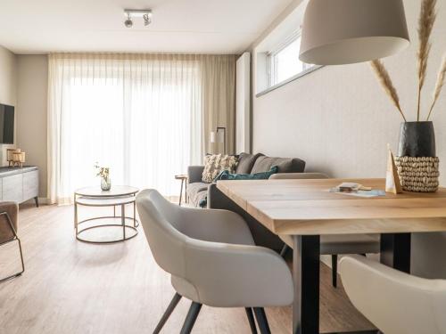 a living room with a table and chairs at Sunny Bungalow in Heart of Texel in De Cocksdorp