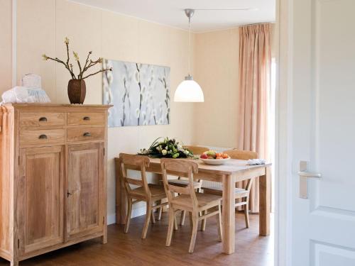 a kitchen and dining room with a table and chairs at Stylish Farmhouse Escape in Wierden