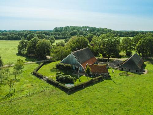 an aerial view of a house in a field at Stylish Farmhouse Escape in Wierden