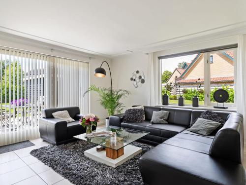 a living room with a couch and a table at Quaint Holiday Home in Putten with Garden in Putten