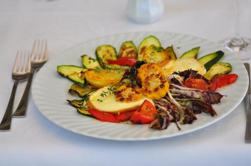 a plate of food with vegetables on a table at Bad St Isidor in Bolzano