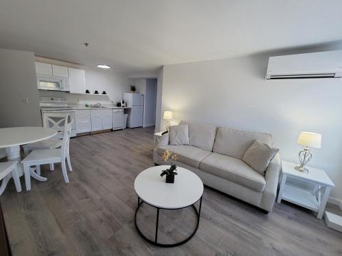 a living room with a couch and a table at The Grand Beach Inn in Old Orchard Beach