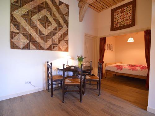 a room with a table and chairs and a bed at Farmhouse in Geesteren near Forests in Geesteren