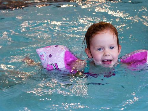 a little girl in the water in a pool at Tranquil Forest Retreat in Dalfsen