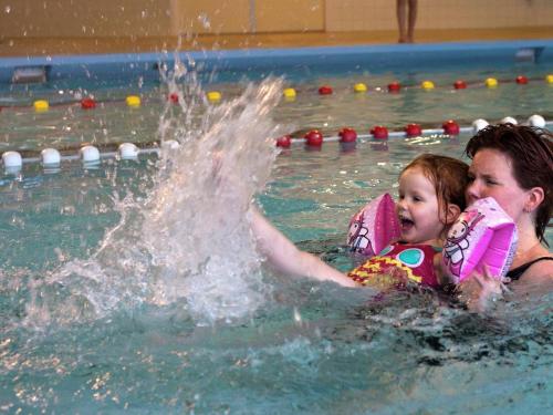 a woman and a little girl in a swimming pool at Tranquil Forest Retreat in Dalfsen