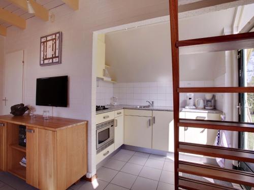 a kitchen with a bunk bed in a room at Tranquil Forest Retreat in Dalfsen