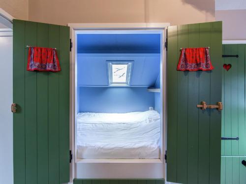 a bedroom with green and blue walls and a bed at Holiday home in De Bult near Giethoorn Waters in De Bult