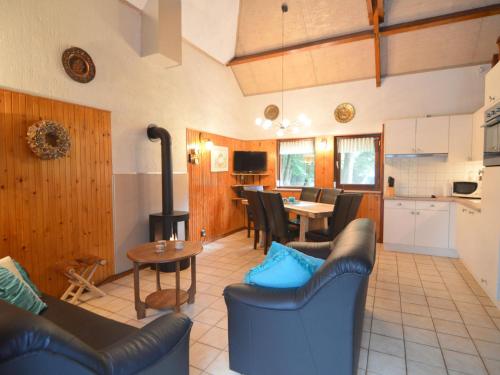 een woonkamer met banken, een keuken en een tafel bij Cozy Holiday Home in Uden with huge private garden in Uden