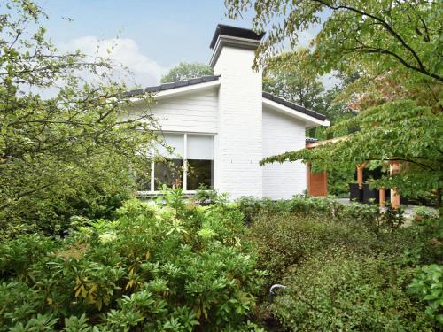 ホルテンにあるLovely holiday home in Rijssen Holten with gardenの木々や茂みに囲まれた白い家