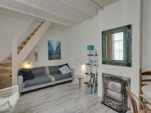a living room with a couch and a fireplace at Picturesque fisherman s house near the beach in Scheveningen