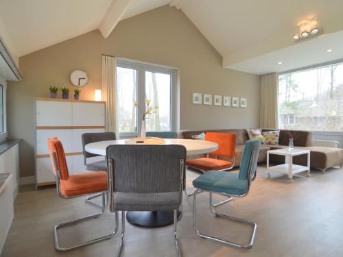 a living room with a table and chairs at Forest Retreat Near Kempen-Broek in De Horst
