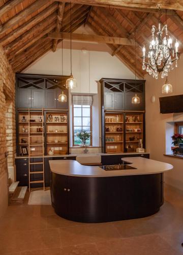 a large kitchen with a large island in a room at The Studio in Castle Bytham