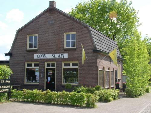 a brick building with a sign that reads guild stall at Holiday Home in Leende with Hot Tub & Garden in Leende