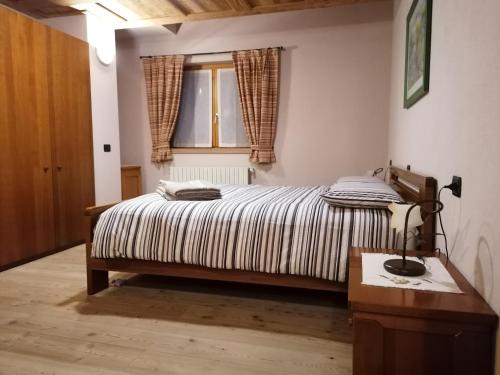 Кровать или кровати в номере Taverna Larice