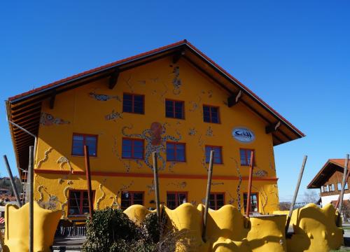 a yellow building with a painting on it at Schiff Bihlerdorf - Hostel in Bihlerdorf