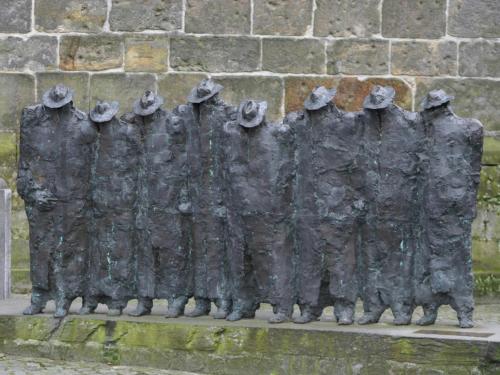 a metal statue in front of a brick wall at Chalet in Netherlands with Private Garden in Ootmarsum