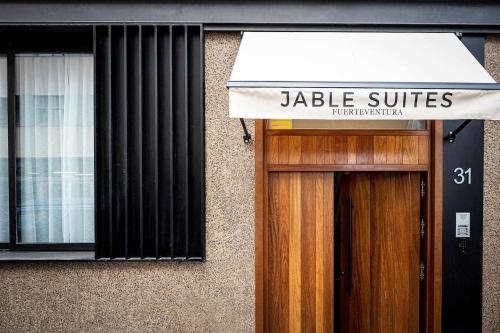 a building with a jedia suites sign above a door at Jable suites apartamentos de lujo en el centro in Corralejo