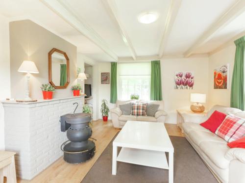 a living room with a couch and a table at Authentic holiday home near Baarn Utrecht on an estate in Baarn