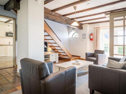 a living room with a couch and a table at Great Farmhouse in De Cocksdorp with Garden in De Cocksdorp