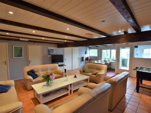 a living room with couches and a table and a piano at Quaint Farmhouse near River in Oosterwijk in Leerdam