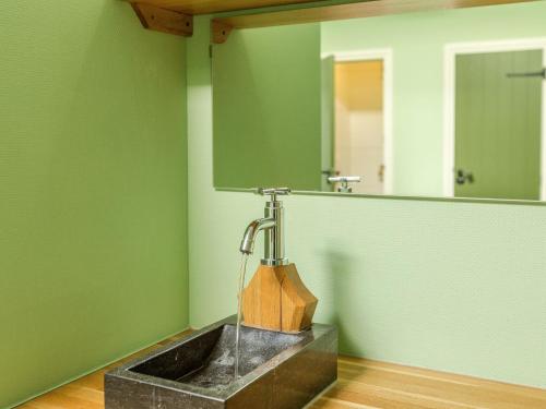 a bathroom with a sink and a mirror at Unique Stay with Cozy Alcoves in De Bult