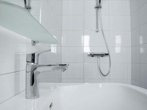 a bathroom with a shower and a sink with a faucet at Forest Lodge in De Bult near Pool & Restaurant in De Bult