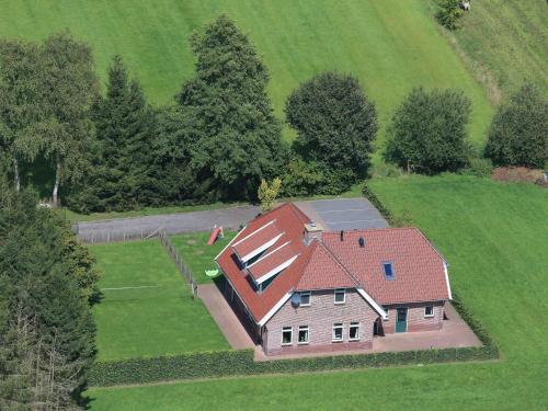 an aerial view of a large house in a field at Spacious farmhouse in Achterhoek with play loft in Neede