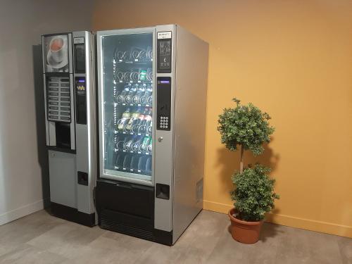 a vending machine with a display of wine glasses at Hotel Martinez Grenay in Grenay