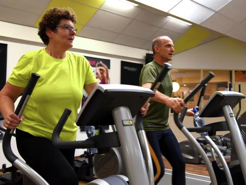 two people exercising on treadmills in a gym at Chalet in Netherlands near Forest & Water in Dalfsen