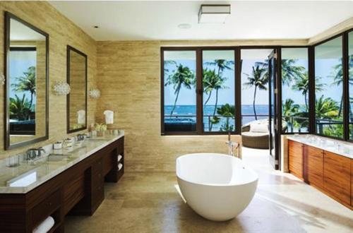 a large bathroom with a large tub and a view of the ocean at Residences at Dorado Beach, a Ritz Carlton Reserve in Dorado