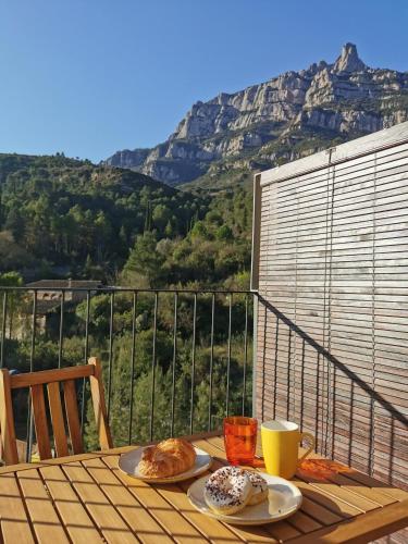 a table with two plates of pastries on top of a balcony at Apartaments Agulles de Montserrat in Monistrol