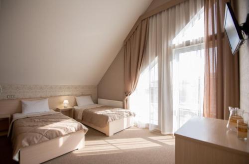 En eller flere senge i et værelse på Гостевой дом "Ламберт"