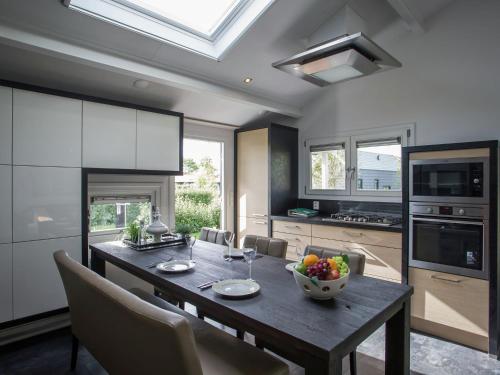 a kitchen with a table with a bowl of fruit on it at Terrace Apartment in Kattendijke in Kattendijke