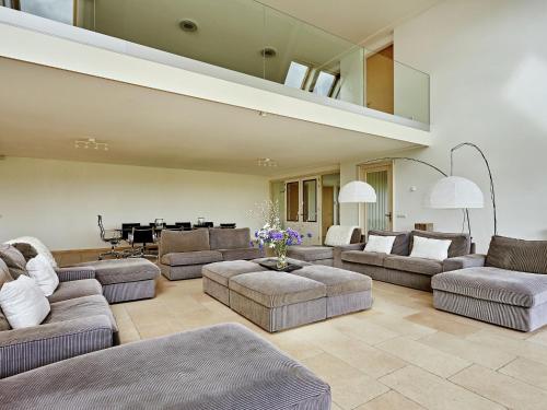 a large living room with couches and a piano at Modern large villa on the mudflats in Friesland in Wierum