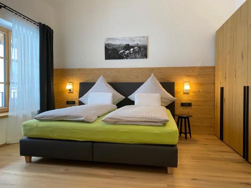 a bedroom with a bed and a table in it at Alpenchalet Iseler in Oberjoch