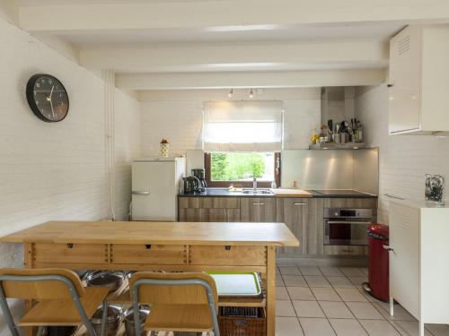 eine Küche mit einem Holztisch und einem Kühlschrank in der Unterkunft Lovely holiday home in Wolphaartsdijk close to the lake in Wolphaartsdijk