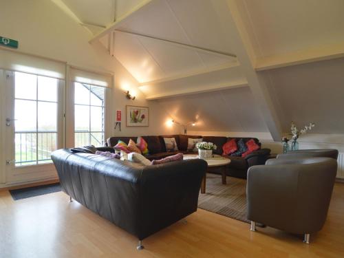 a living room with a couch and a table at Luxury Holiday Home In Noordbeemster in Noordbeemster