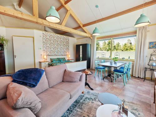 a living room with a couch and a table at Farmhouse in Eastermar near De Leijen River in Hoogzand