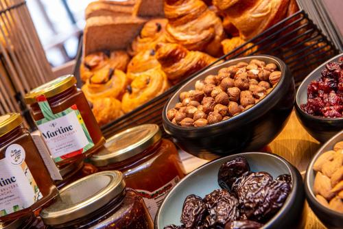 a bunch of different types of pastries on a table at Radisson Blu Hotel, Rouen Centre in Rouen